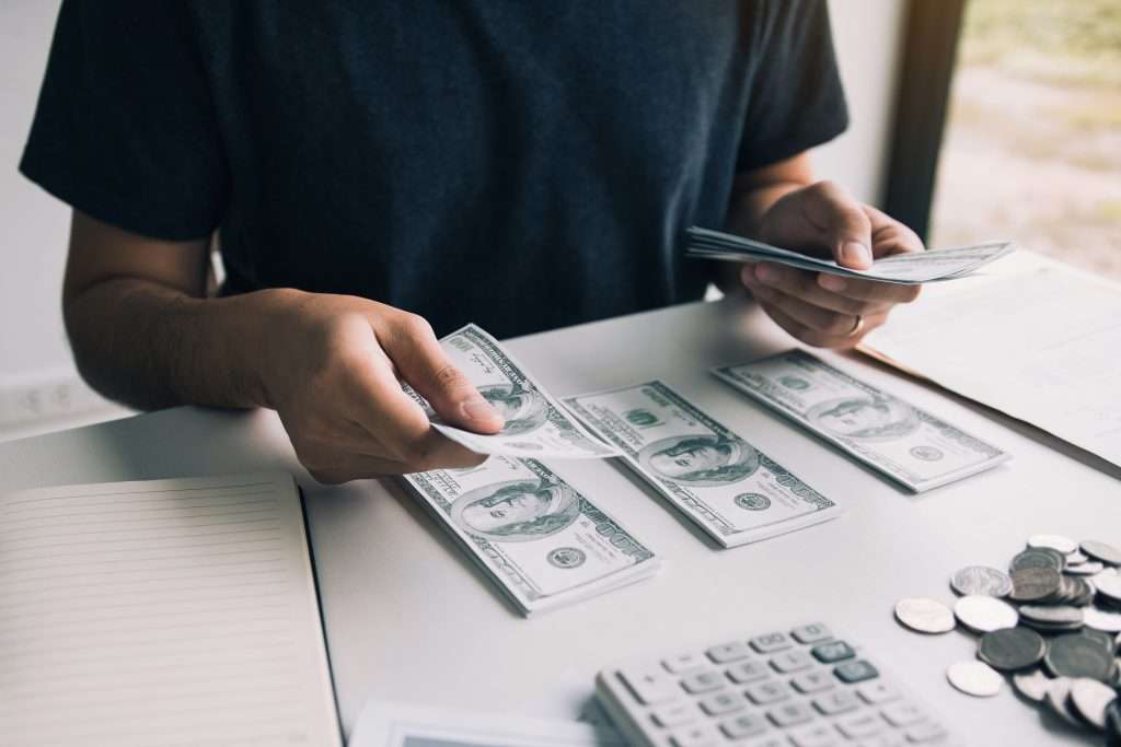 Holding banknotes in cash and placed on the table