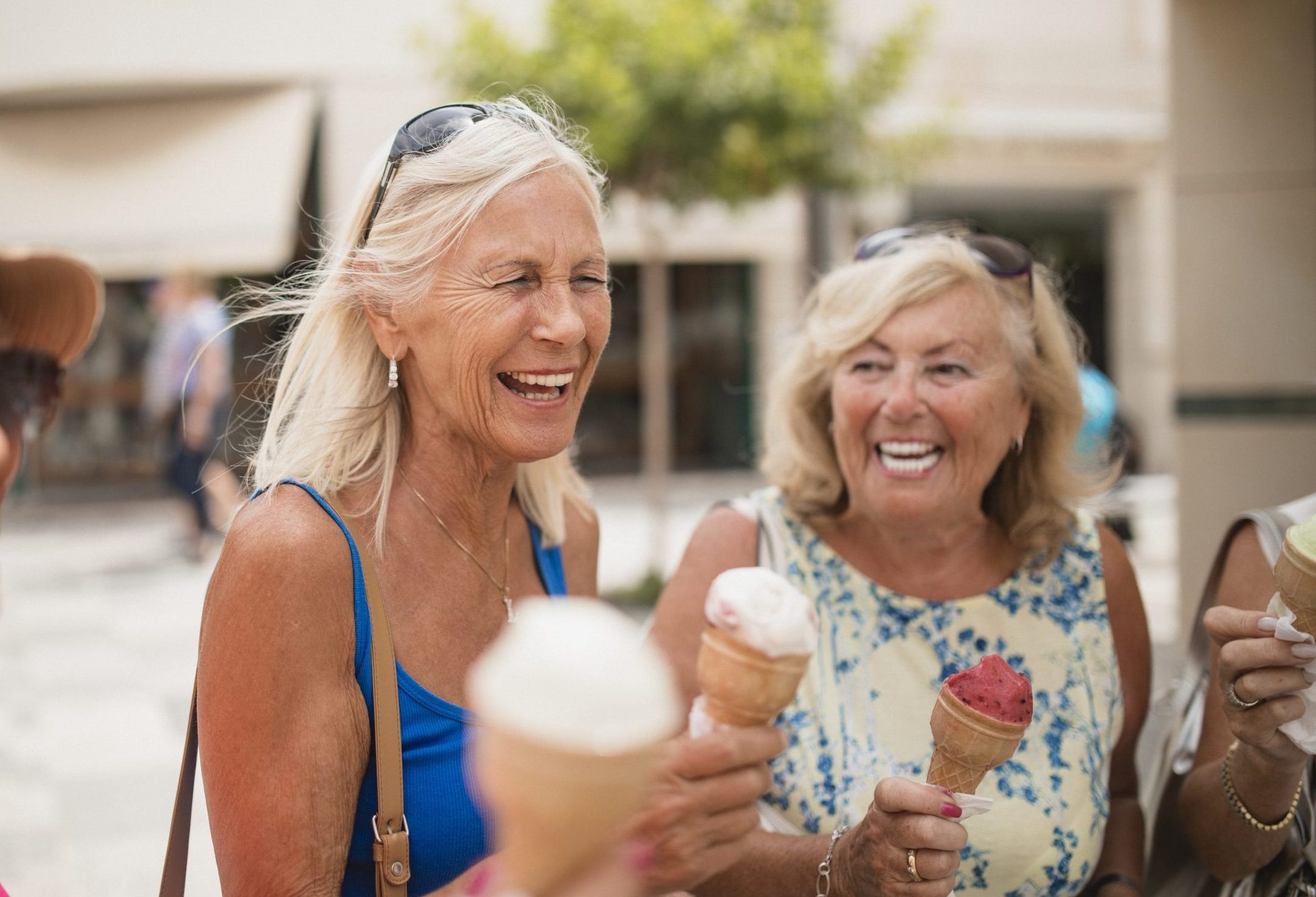 Four retired older woman friends on holiday in Cyprus are enjoying ice cream cones. mid-year retirement checkup