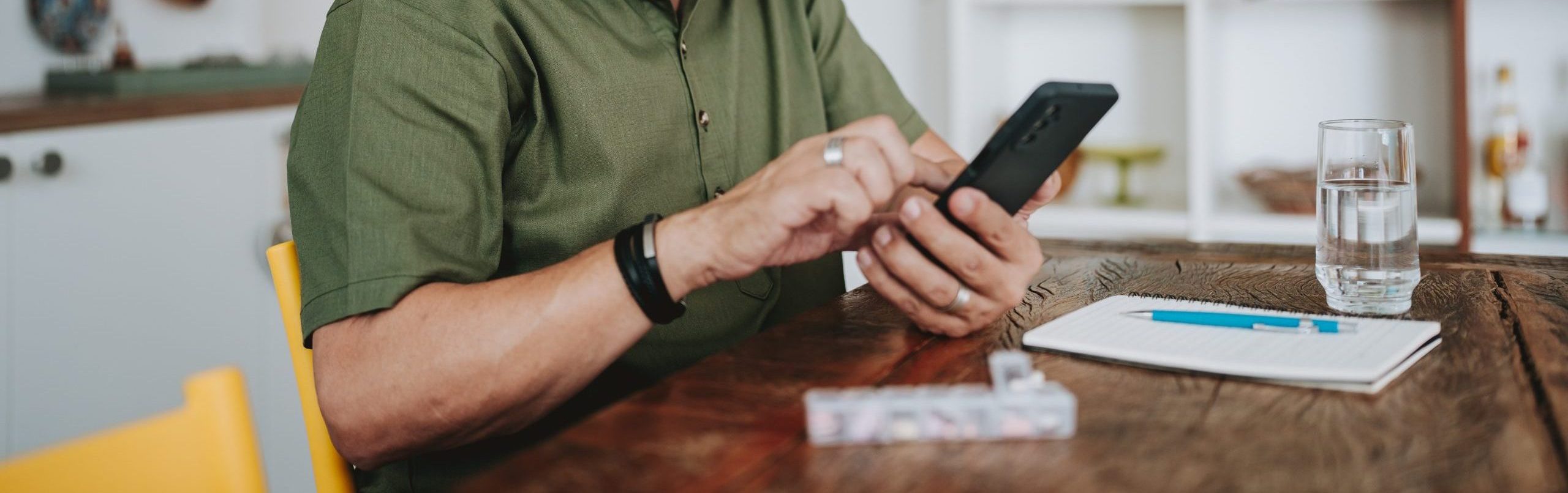 Elderly man checking medical prescription on smartphone Retired couple preparing for Medicare Open Enrollment 2026 and reviewing health care expenses