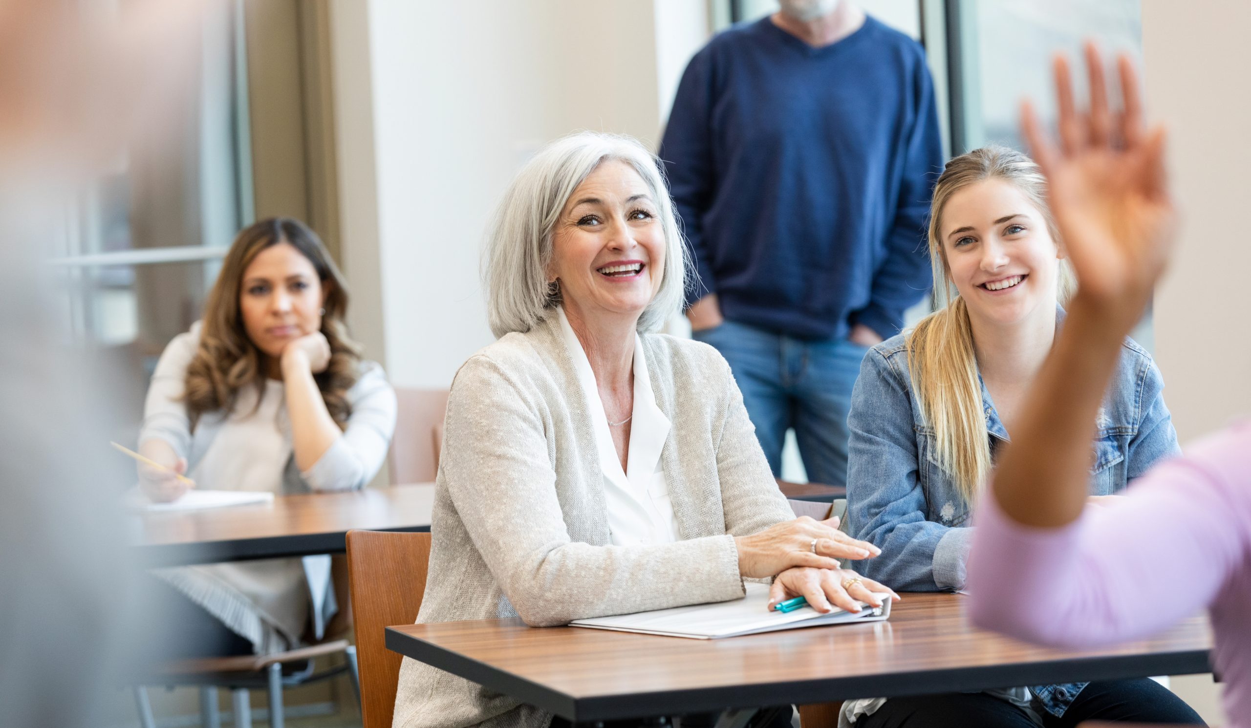 Adults participate actively in a lesson or meeting, showing engagement and interest in the subject.