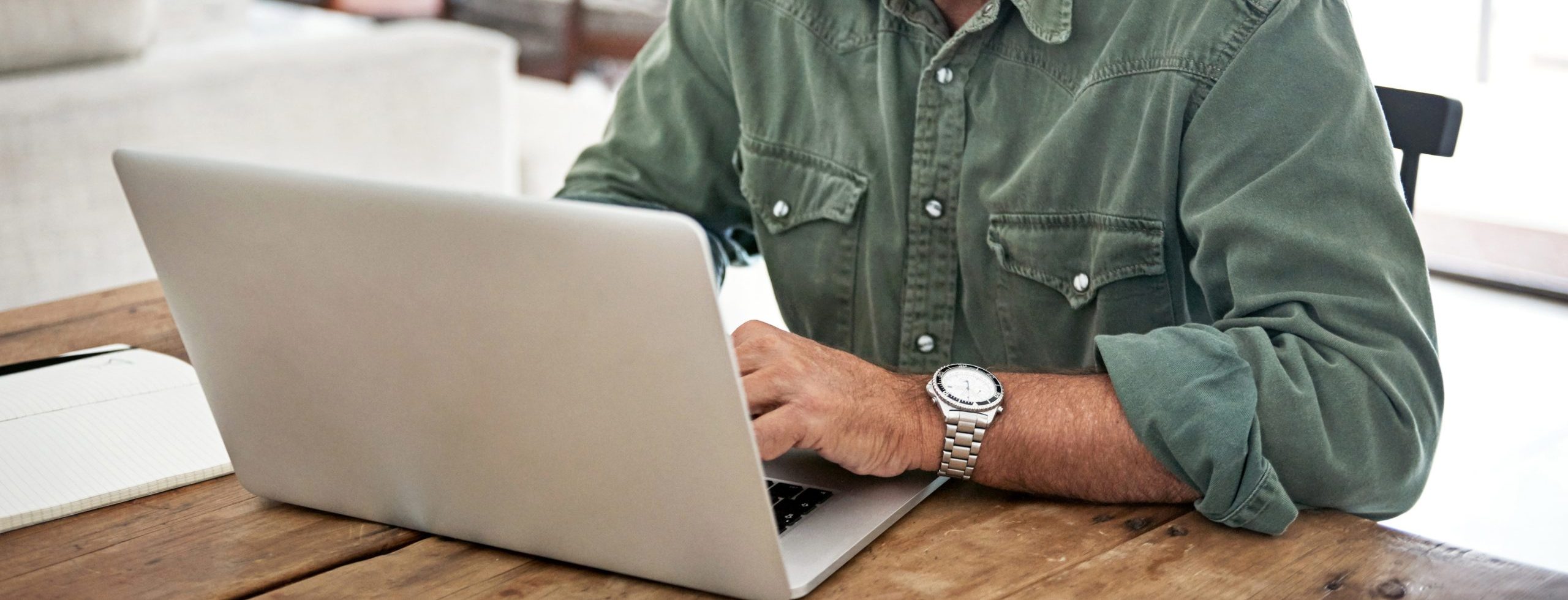 Cropped shot of a mature man working on his laptop at home